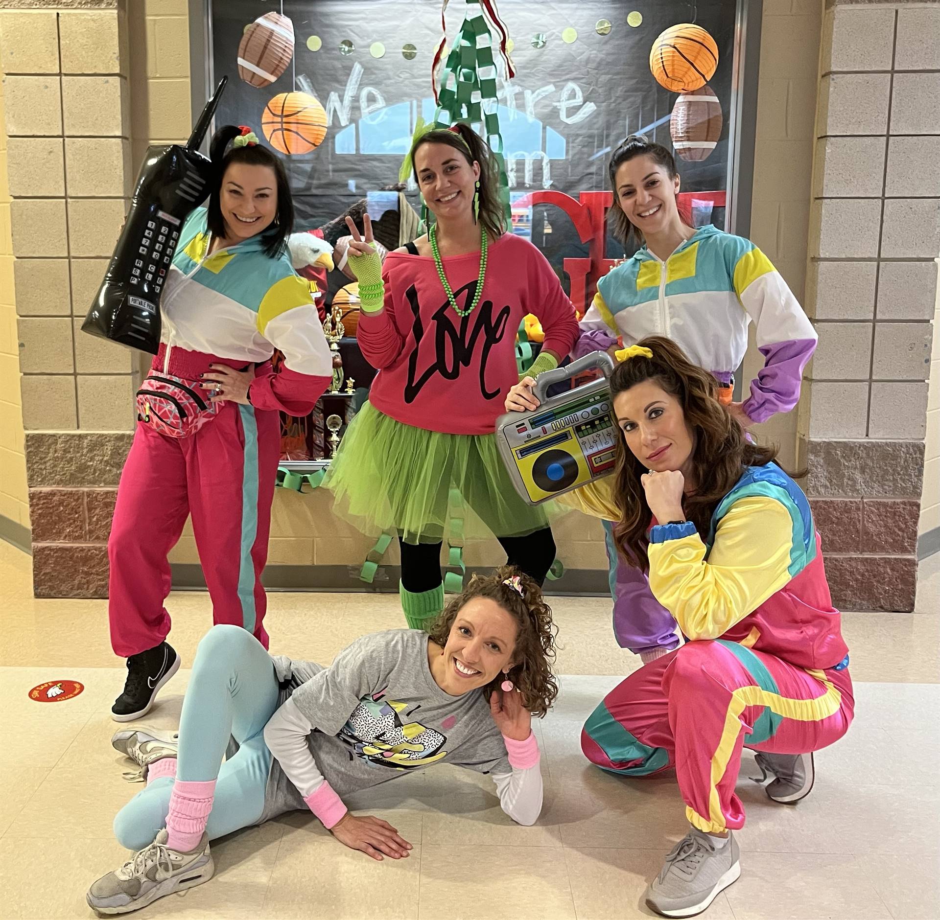 5 Teachers all dressed in 1980&#39;s nylon sweat suits pose for Flashback Friday Decade day