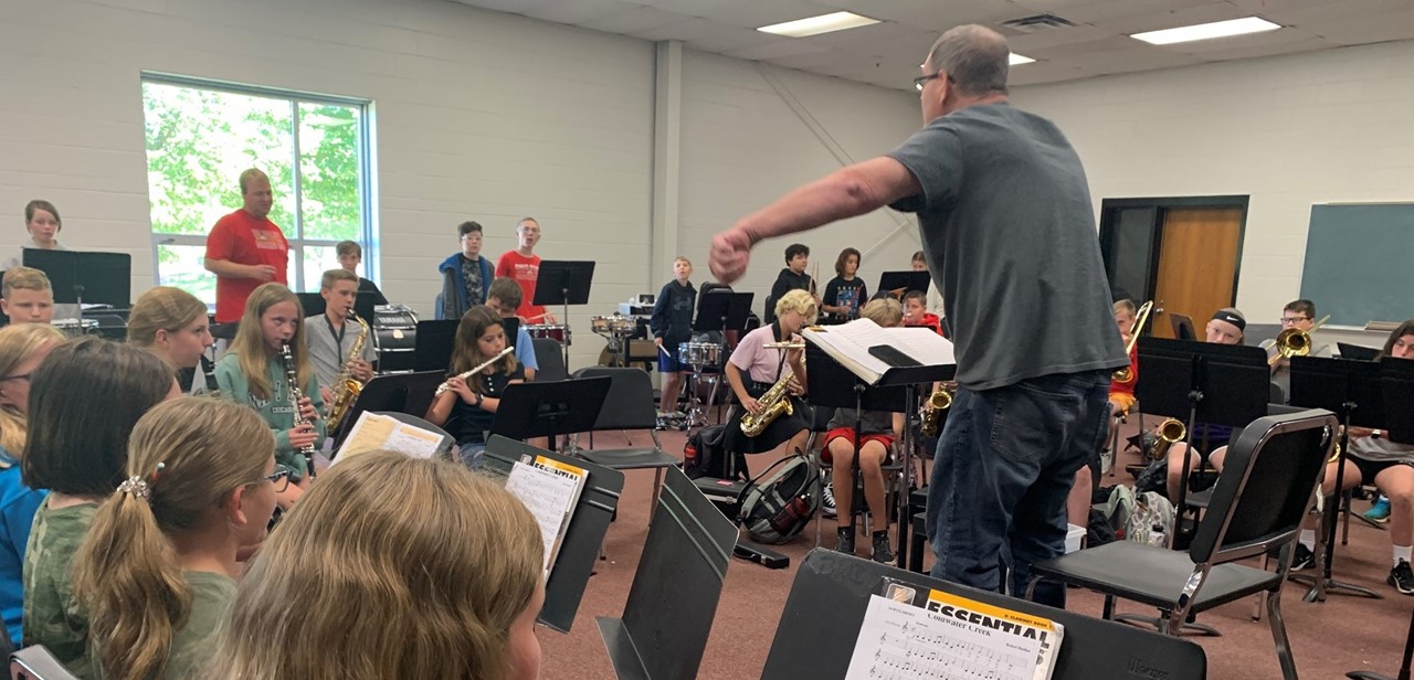 Middle school band students playing music in classroom