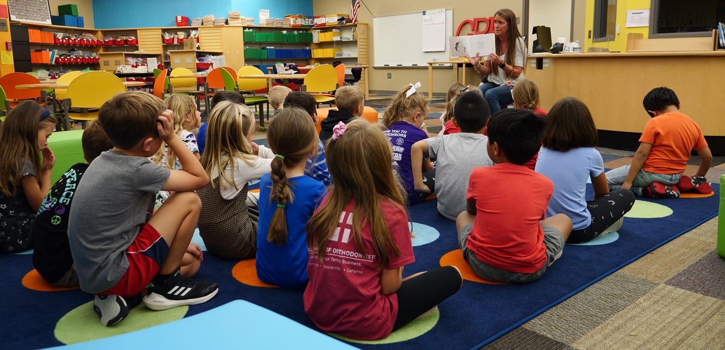 Group of students in the library being read a book in General Rosecrans Elementary