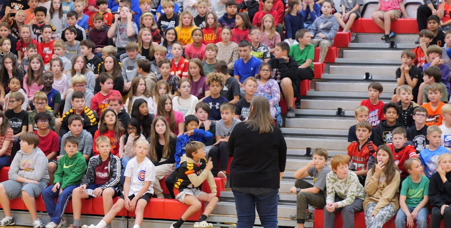 Big Walnut Intermediate School Principal Sandrock speaking to students at an assembly