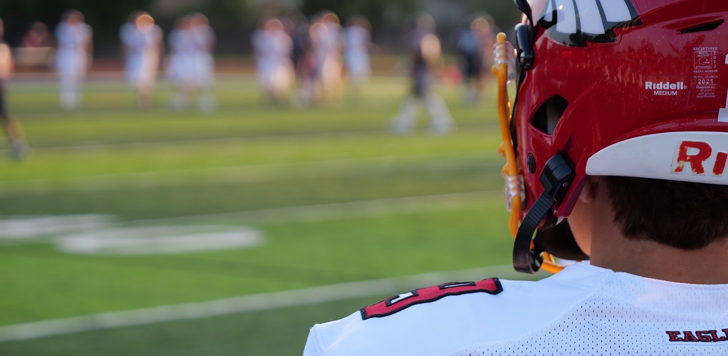 Football player looks on during a play vs. Bishop Hartley