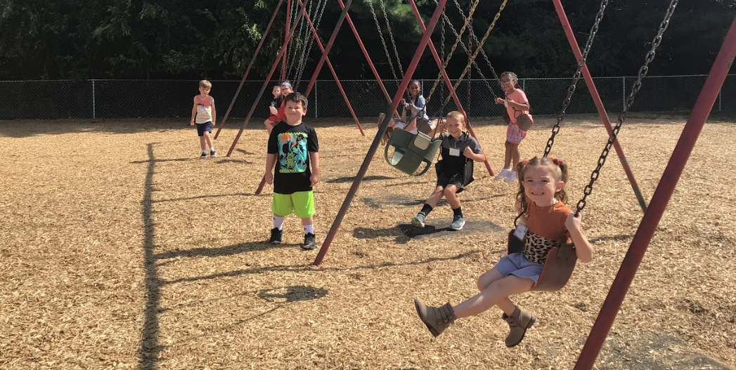 Recess time at Big Walnut Elementary - students on the swings