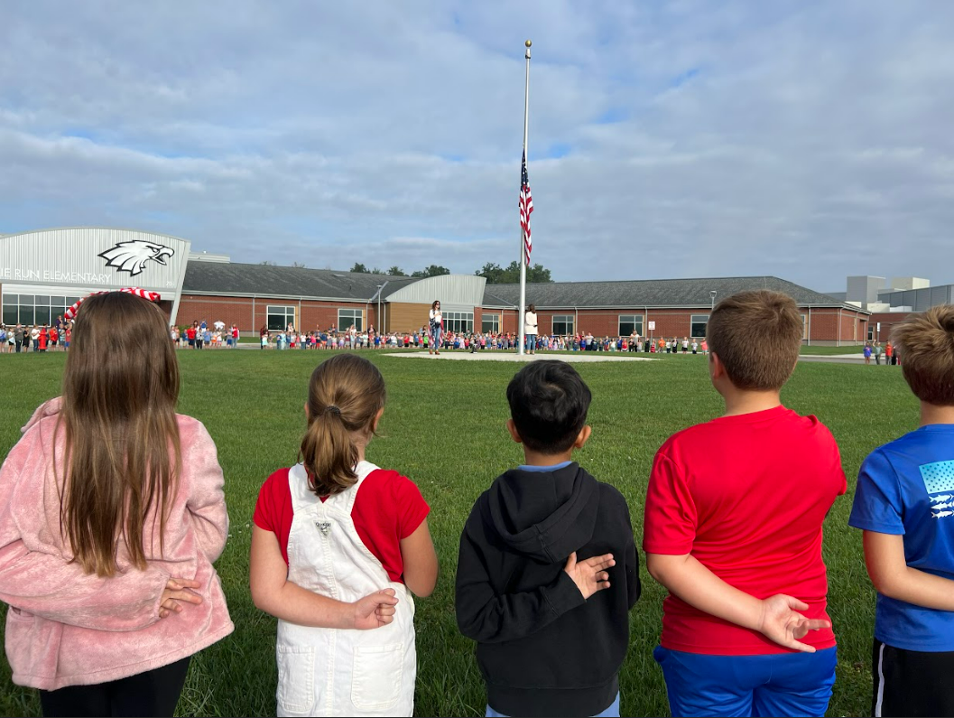 Students gather around the flagpole for a 9/11 ceremony
