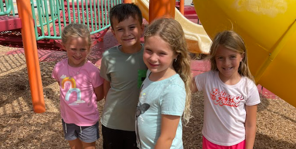 Recess time at General Rosecrans Elementary - students pose on the playground