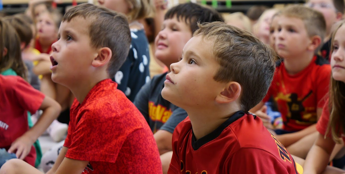 Students listen intently at an assembly