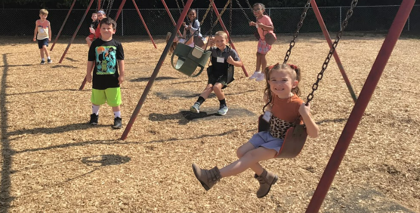 Recess time at Big Walnut Elementary - students on the swings