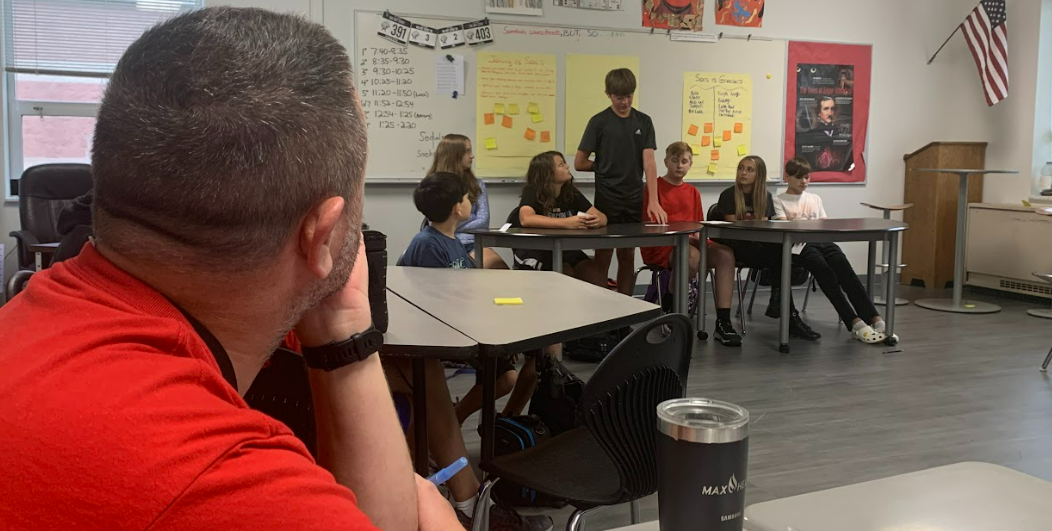 A teacher listens in to a student presentation at Big Walnut Middle School