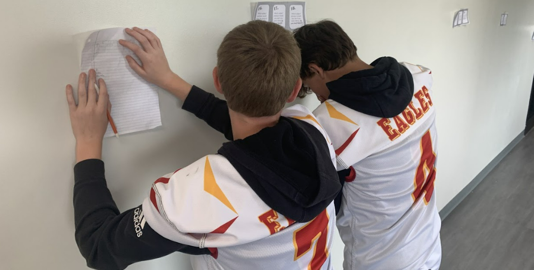 Big Walnut Middle School football players doing homework  in the hallway