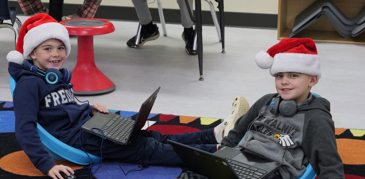 A couple of Big Walnut Elementary students relax with their Santa hats