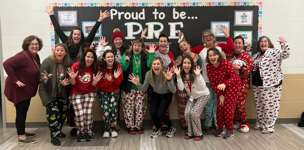 Teachers posing at Prairie Run Elementary in their Christmas pajamas