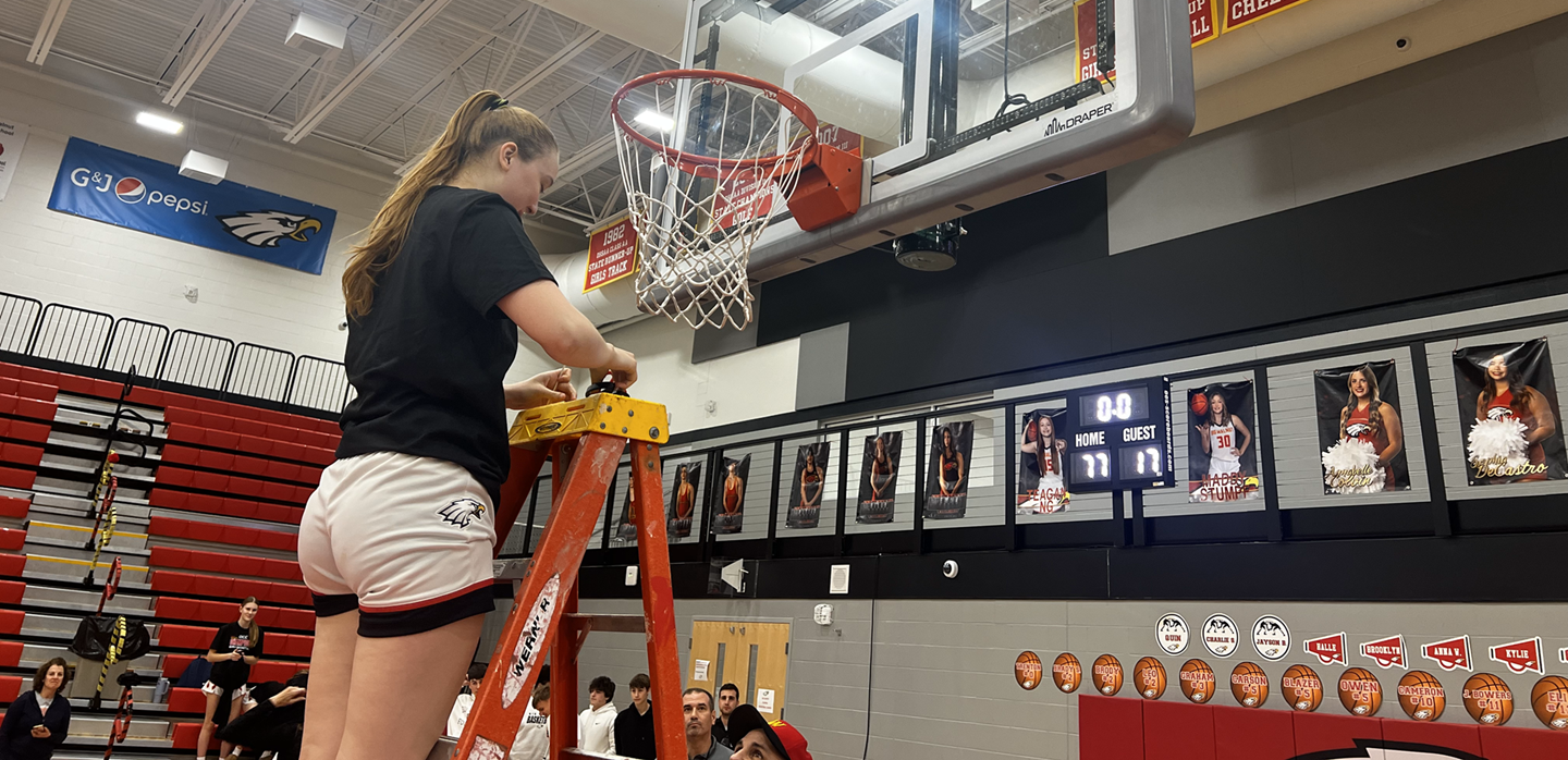 A Big Walnut High School girls basketball player cuts down the net