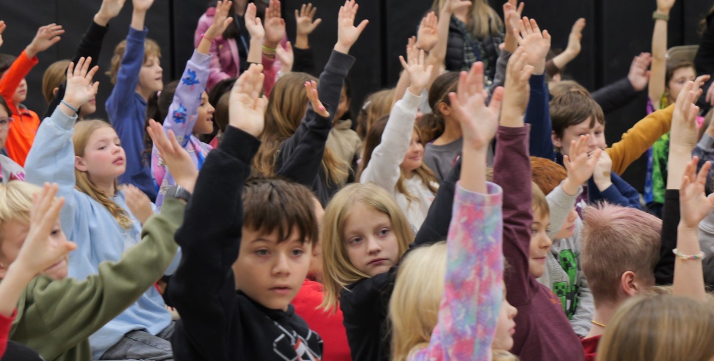 Hylen Souders Students raise their hands at an assembly