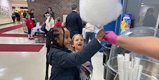 A student receives cotton candy at Big Walnut Elementary