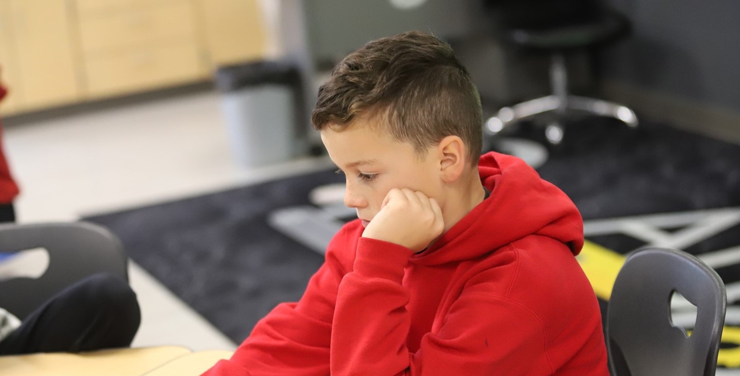 Student working with technology at PRE