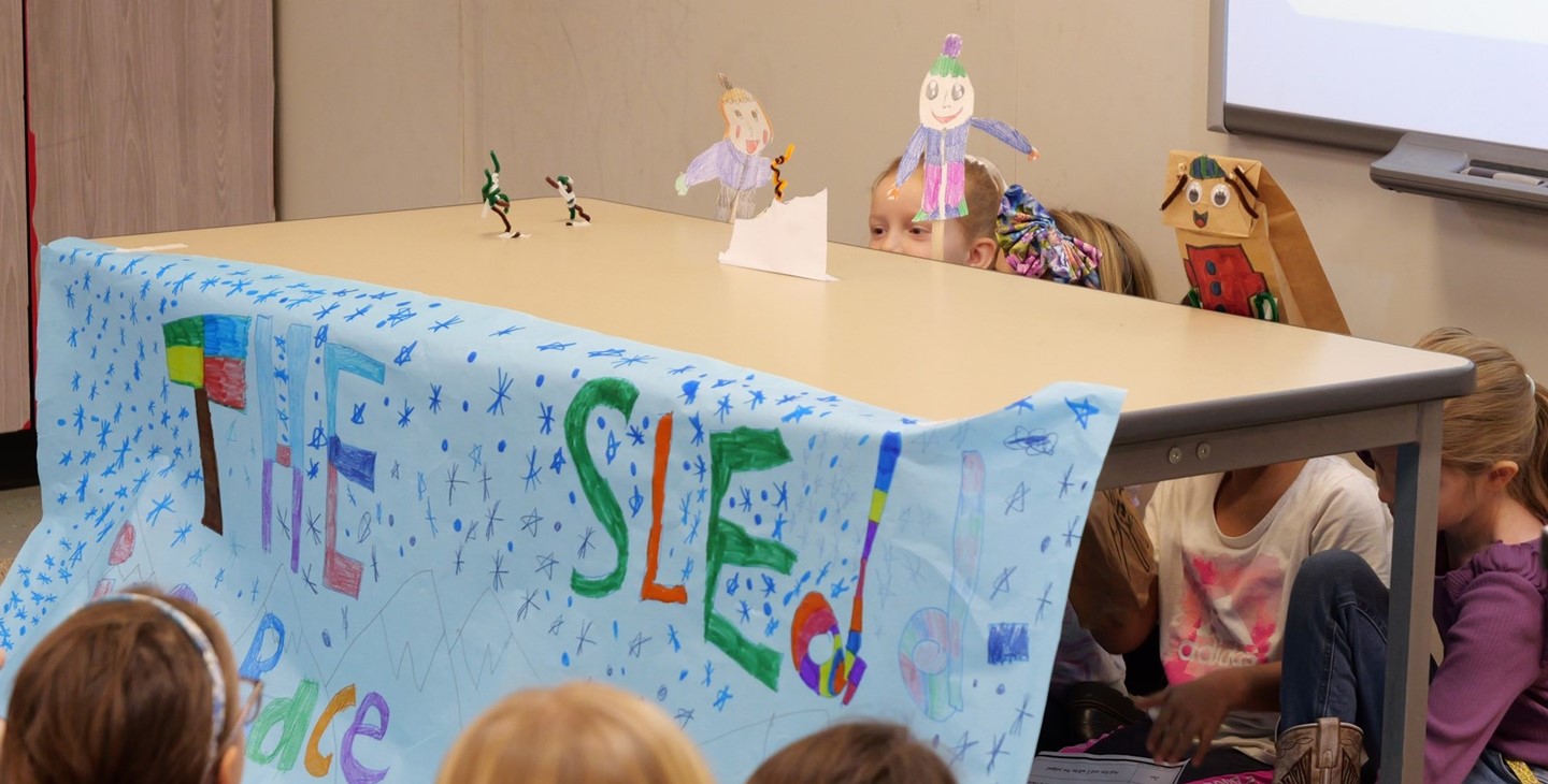 Students perform a puppet show