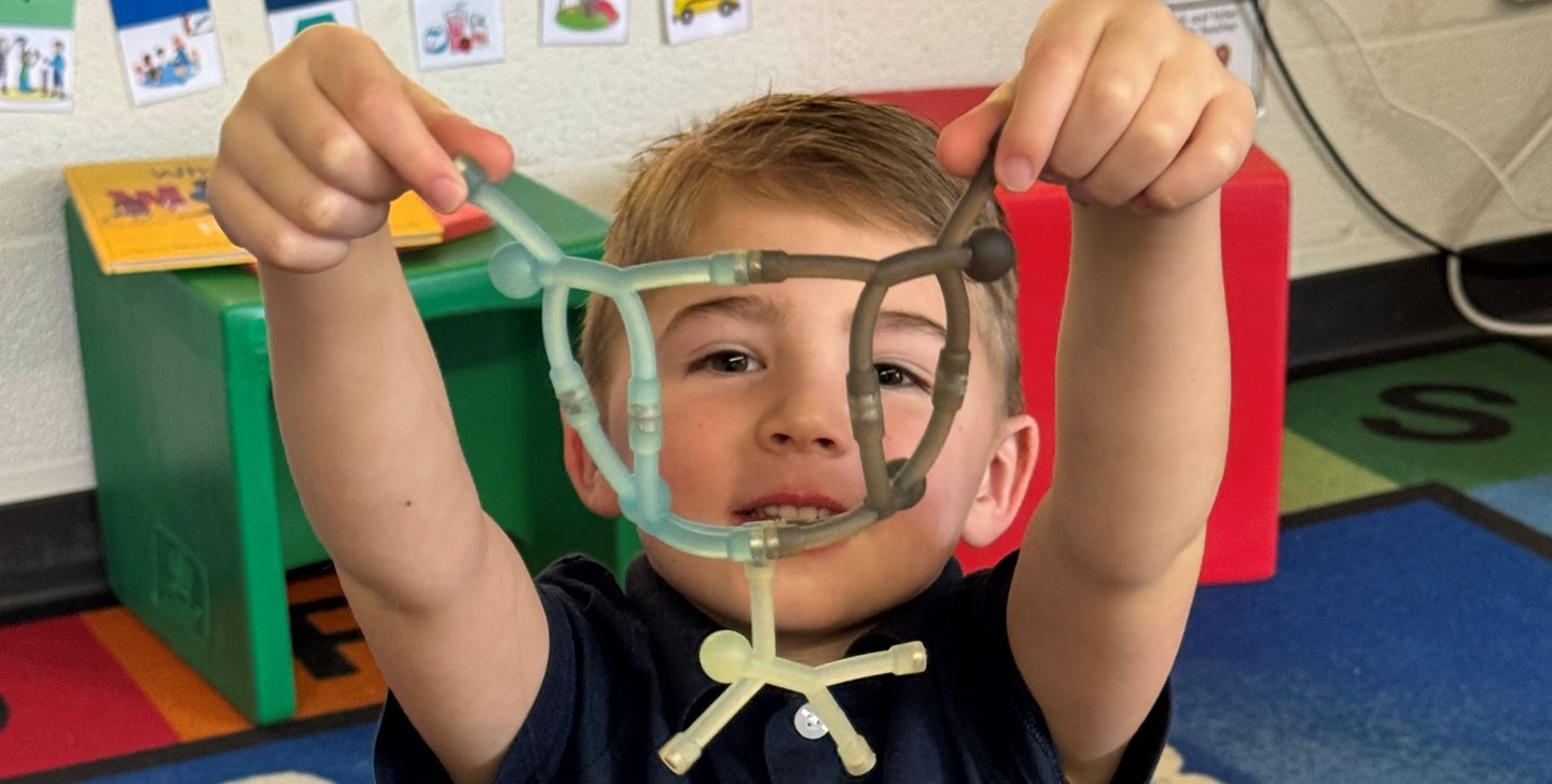 a student shows off his toy creation